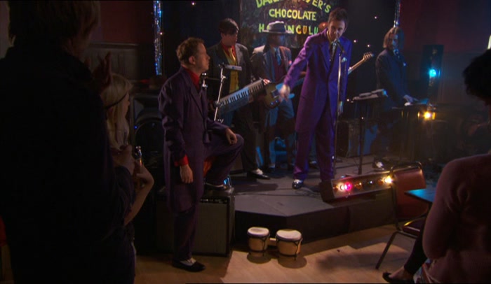 HE IS NOT IN THE BAND, HE IS MERELY DRESSED LIKE THE BAND. 