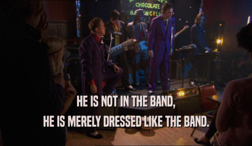 HE IS NOT IN THE BAND, HE IS MERELY DRESSED LIKE THE BAND. 