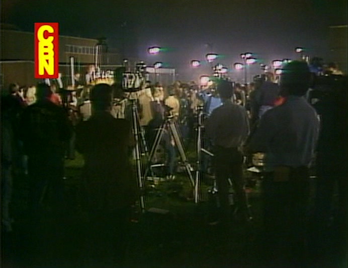 PRESS AND PROTESTERS CONDUCT A SILENT VIGIL OUTSIDE THIS DISGRACELAND. 