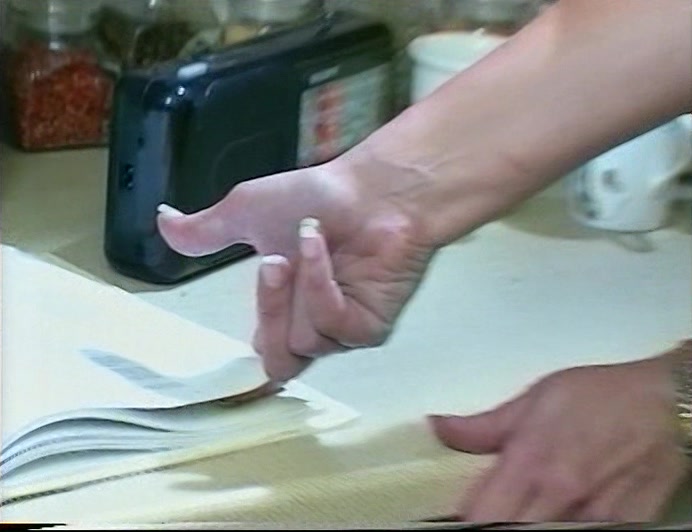 WHO HAD HER FINGER TRAPPED UNDER THE PAGE OF A BOOK. 