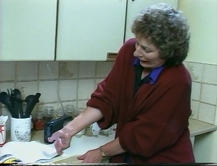 WHO HAD HER FINGER TRAPPED UNDER THE PAGE OF A BOOK. 