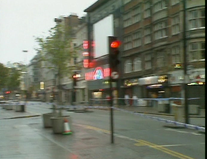 OXFORD STREET IN LONDON, WITH THREE POLICEMEN AND A KNOTTED TAPE BARRIER. 