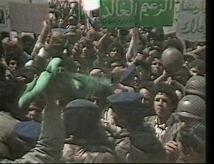CROWDS IN TRIPOLI WELCOMED THE NEWS, A DELIGHTED GADDAFI WAVING LIKE A GIRL. 