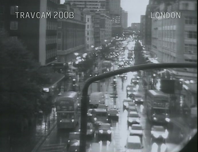 LOTS OF CARS BEING SLOWED DOWN BY THEIR OWN LIGHTS. 