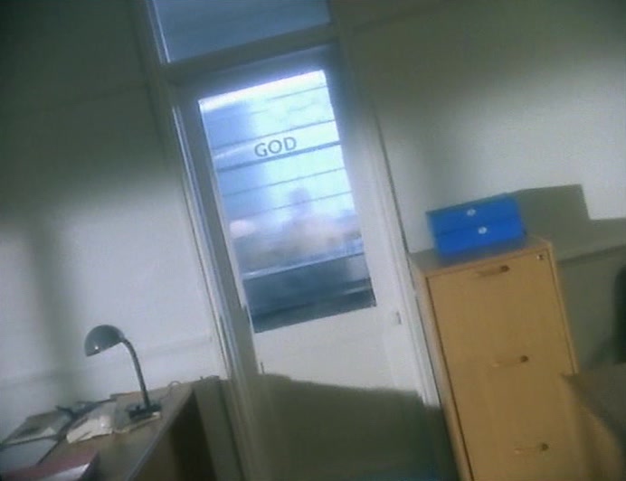 SHE LED ME INTO AN OPEN-PLAN OFFICE, AND AT THE BACK WAS A LITTLE SEPARATE OFFICE. 