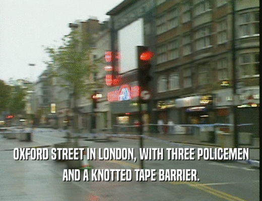 OXFORD STREET IN LONDON, WITH THREE POLICEMEN AND A KNOTTED TAPE BARRIER. 