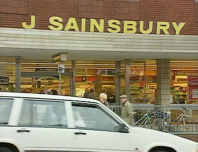CAR DRIVES PAST WINDOW IN TOWN...  