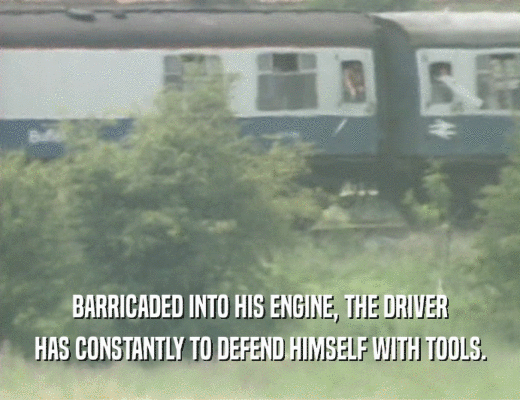 BARRICADED INTO HIS ENGINE, THE DRIVER HAS CONSTANTLY TO DEFEND HIMSELF WITH TOOLS. 